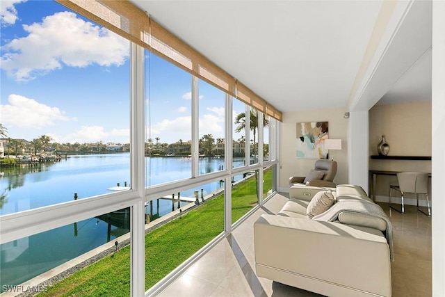 sunroom featuring a water view