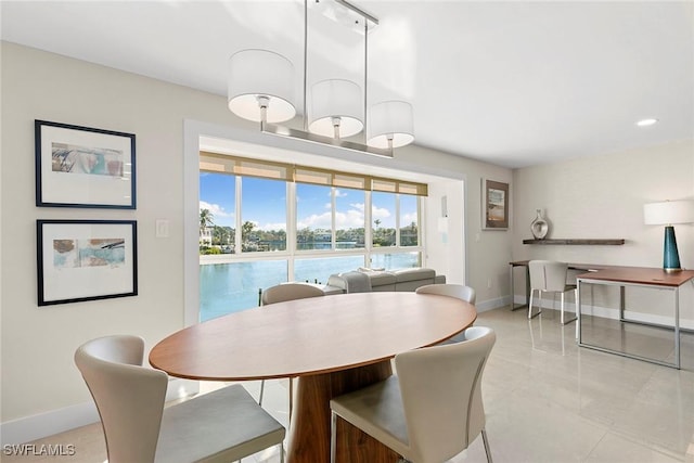 dining space featuring a water view