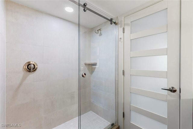 bathroom with a shower with shower door