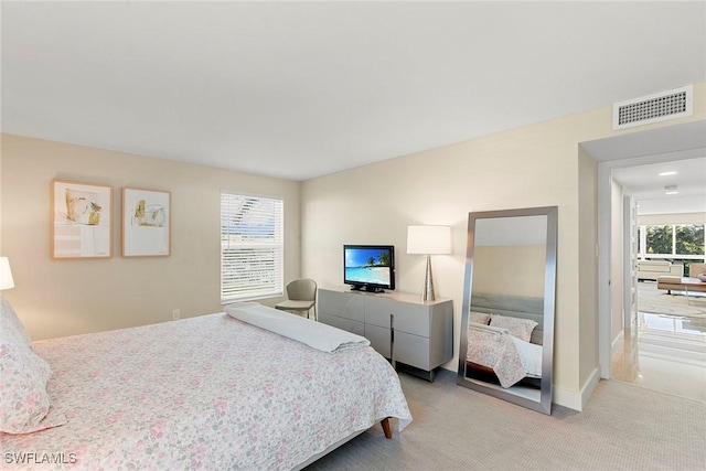 bedroom featuring light colored carpet