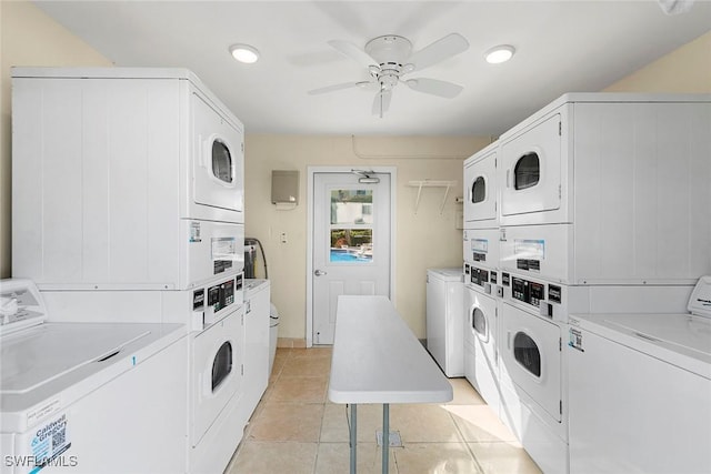 laundry room with stacked washer / dryer, washer and dryer, light tile patterned floors, and ceiling fan