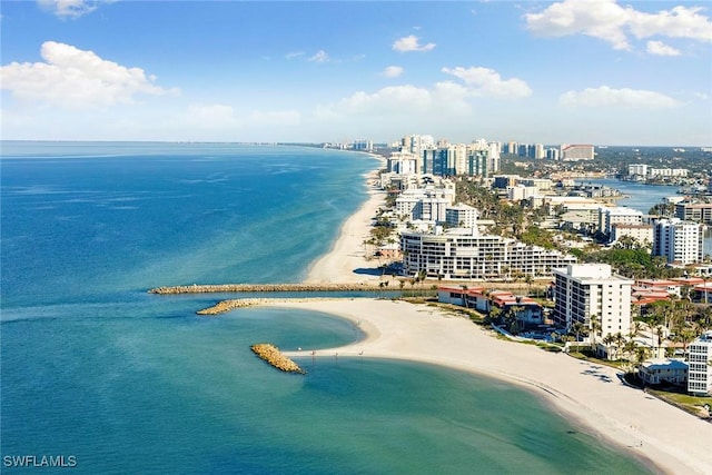 drone / aerial view featuring a beach view and a water view