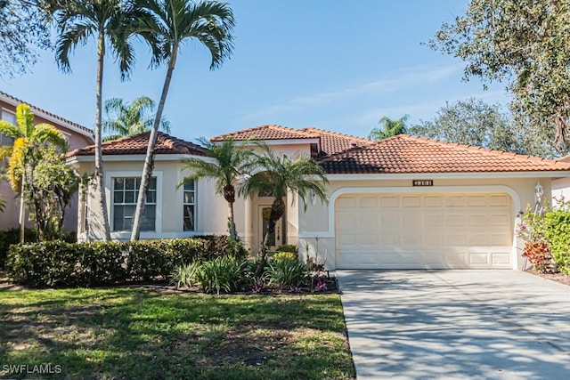 mediterranean / spanish-style house with a garage