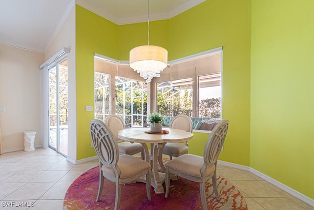 tiled dining area with crown molding and a chandelier