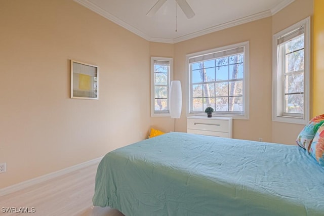 bedroom with ceiling fan, ornamental molding, and multiple windows