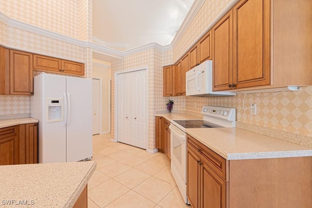 kitchen featuring light tile patterned floors, white appliances, ornamental molding, and light stone countertops