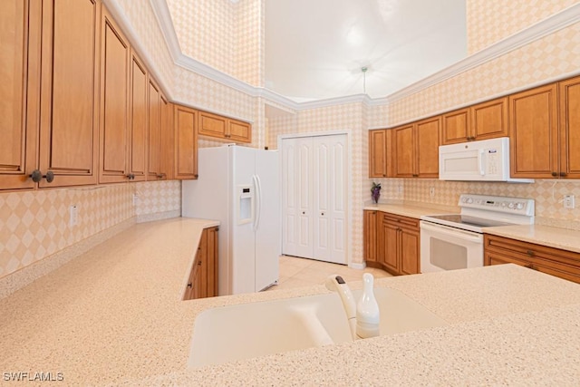 kitchen featuring crown molding, white appliances, sink, and light stone counters