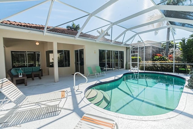 view of pool with an outdoor living space, a lanai, and a patio area