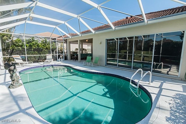 view of pool with a lanai and a patio area