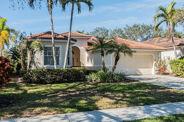 mediterranean / spanish-style home with a garage and a front yard