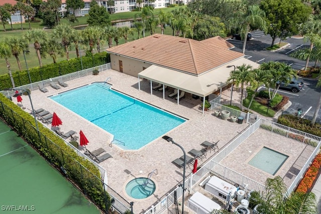 view of swimming pool featuring a patio area and a hot tub