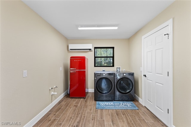 clothes washing area featuring washer and dryer and a wall unit AC