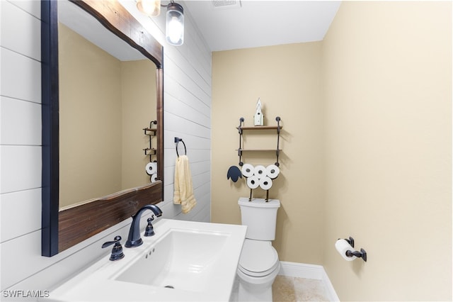 bathroom with tile patterned flooring, sink, and toilet