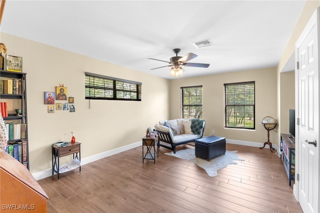 living room featuring hardwood / wood-style flooring and ceiling fan