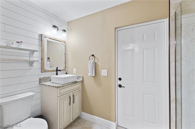 bathroom featuring tile patterned flooring, vanity, and toilet