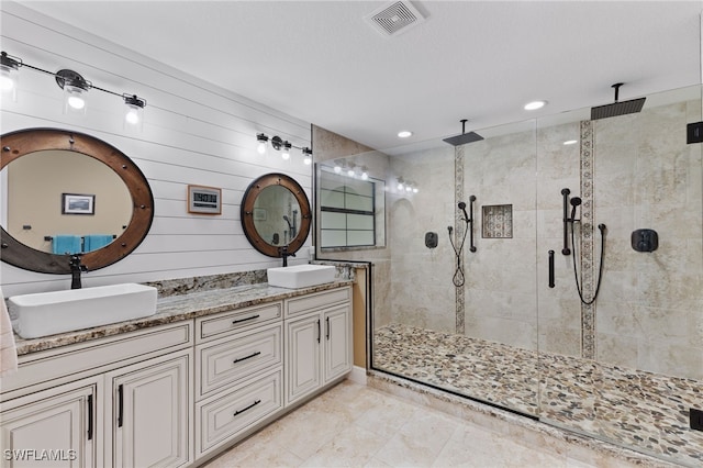 bathroom featuring vanity, wooden walls, and walk in shower