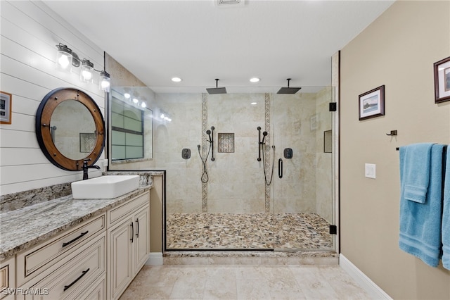 bathroom featuring vanity and a shower with door