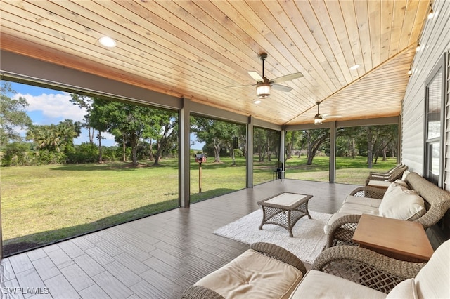 sunroom with ceiling fan, vaulted ceiling, and wooden ceiling