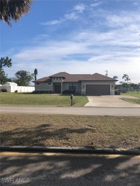 view of front facade with a garage and a front lawn