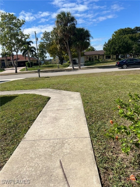 view of home's community with a yard