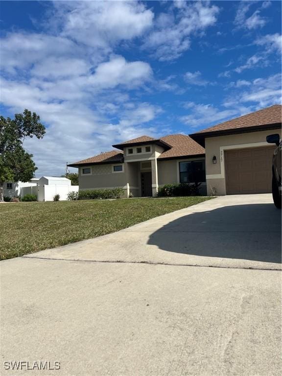 view of front of home featuring a garage and a front lawn