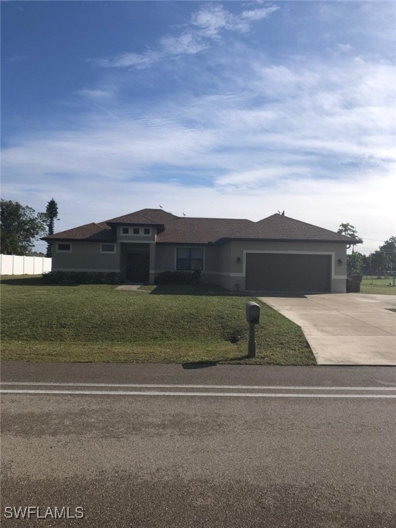 view of front of home featuring a garage and a front lawn