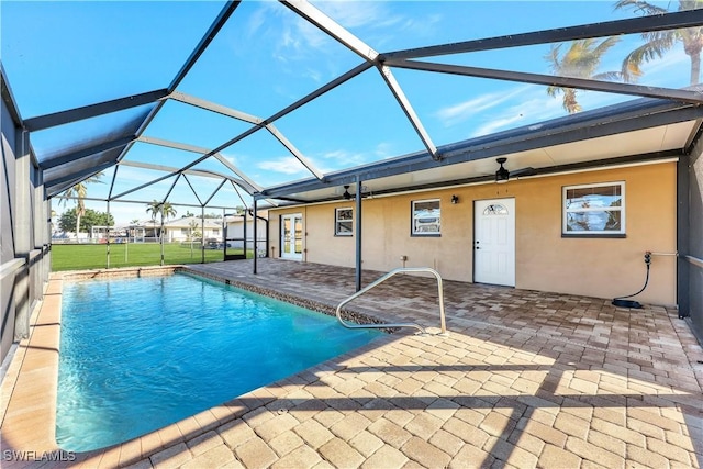 view of swimming pool with a yard, a lanai, a patio, and ceiling fan