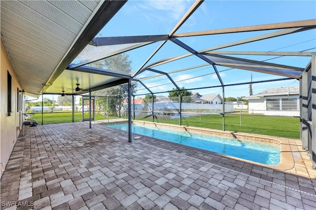 view of pool featuring a patio, a lanai, a yard, and ceiling fan