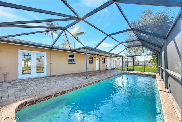 view of swimming pool with a patio, a lanai, and french doors