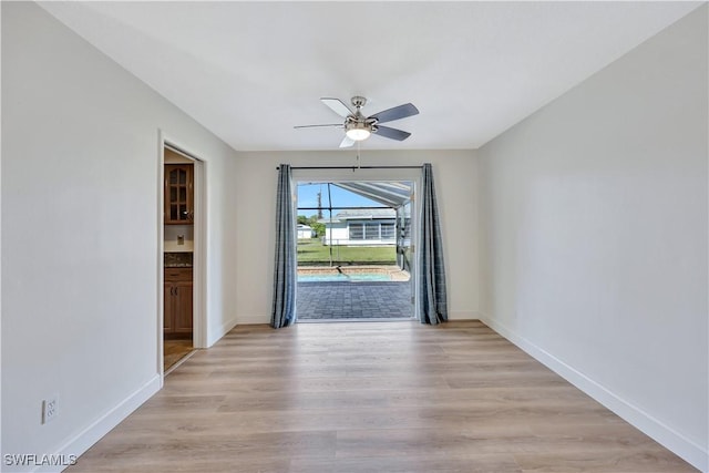 spare room with ceiling fan and light hardwood / wood-style floors