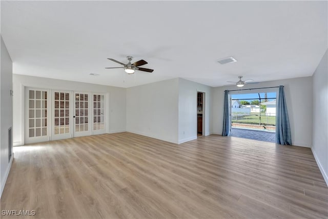 unfurnished living room with french doors, ceiling fan, and light wood-type flooring