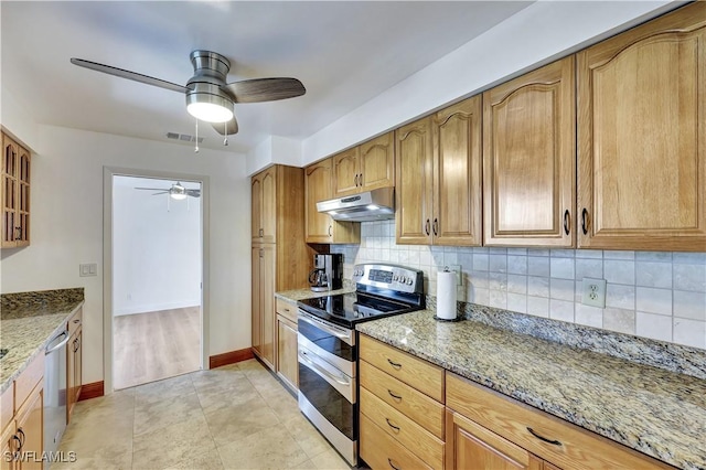 kitchen with light stone counters, ceiling fan, stainless steel appliances, and backsplash