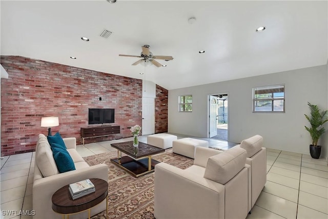 tiled living room featuring ceiling fan, lofted ceiling, and brick wall