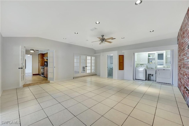 unfurnished living room featuring washer / clothes dryer, light tile patterned floors, and ceiling fan