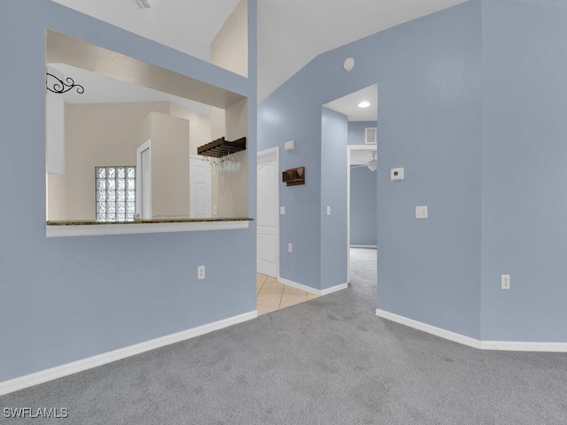 unfurnished living room featuring lofted ceiling, light colored carpet, and ceiling fan