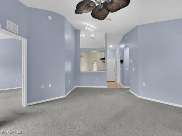 unfurnished living room featuring light colored carpet and vaulted ceiling