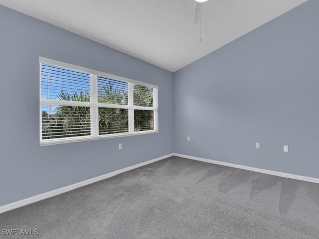 empty room featuring vaulted ceiling, ceiling fan, and carpet