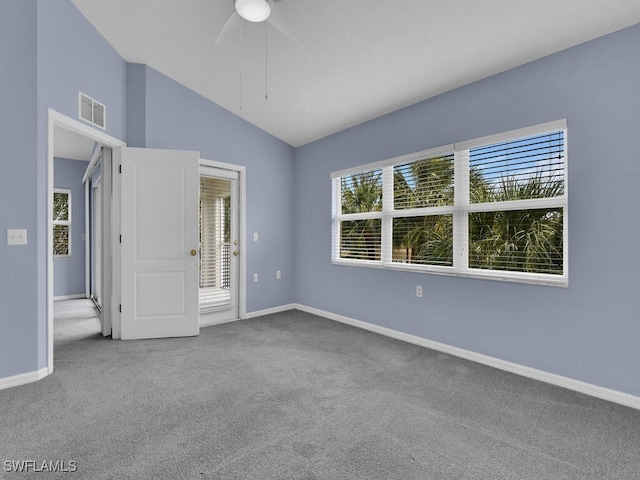 carpeted empty room with vaulted ceiling and ceiling fan