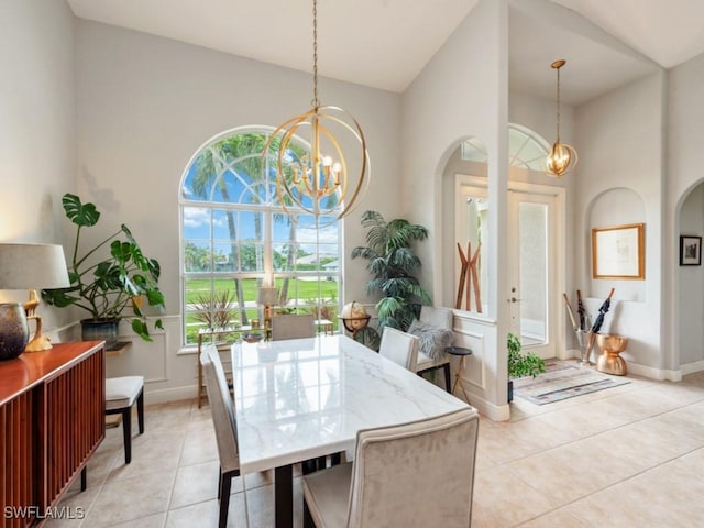 tiled dining area featuring vaulted ceiling and a notable chandelier