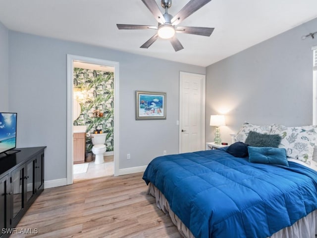 bedroom with ensuite bath, ceiling fan, and light wood-type flooring