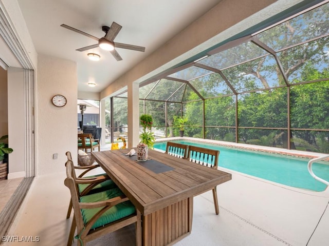 view of swimming pool with a patio, a lanai, and ceiling fan