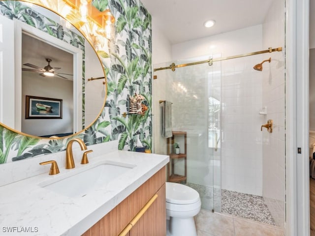 bathroom with vanity, a shower with door, and toilet