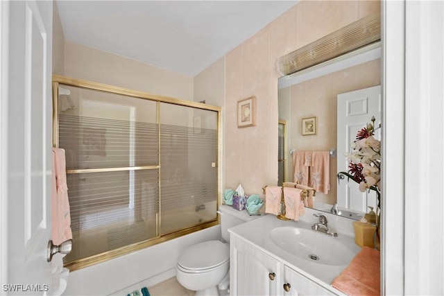 full bathroom featuring enclosed tub / shower combo, vanity, and toilet