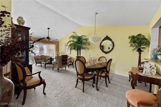 dining room featuring vaulted ceiling, light colored carpet, a textured ceiling, and ceiling fan