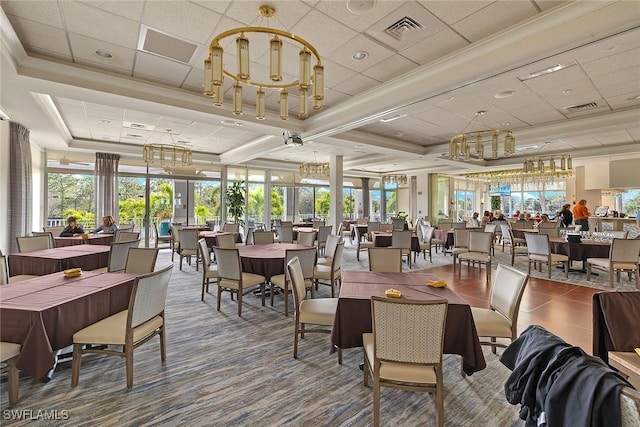 dining space featuring a raised ceiling, crown molding, a drop ceiling, and french doors