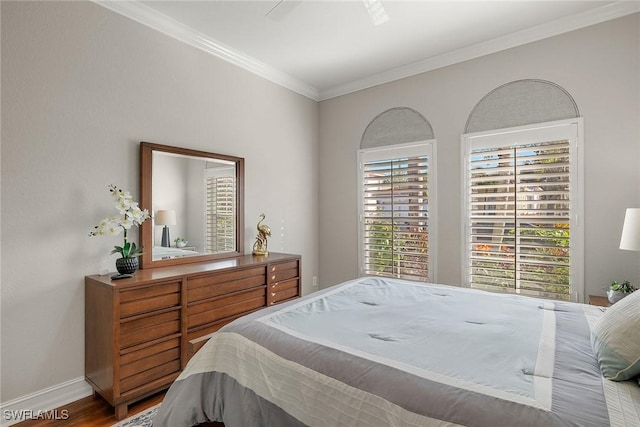 bedroom with ceiling fan, ornamental molding, and wood-type flooring