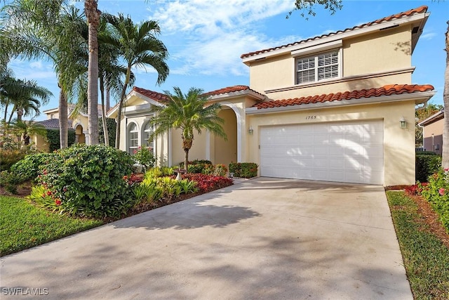 mediterranean / spanish home with a garage