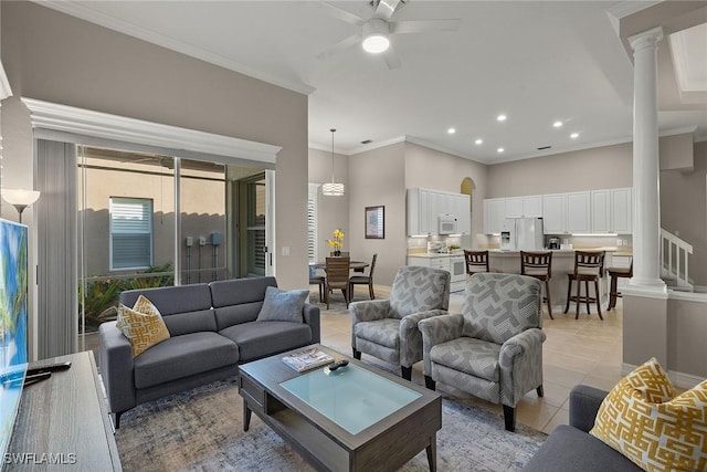 living room featuring ornate columns, crown molding, light tile patterned floors, and ceiling fan