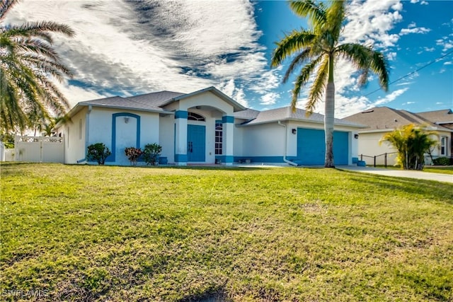 ranch-style home with driveway, an attached garage, fence, a front yard, and stucco siding