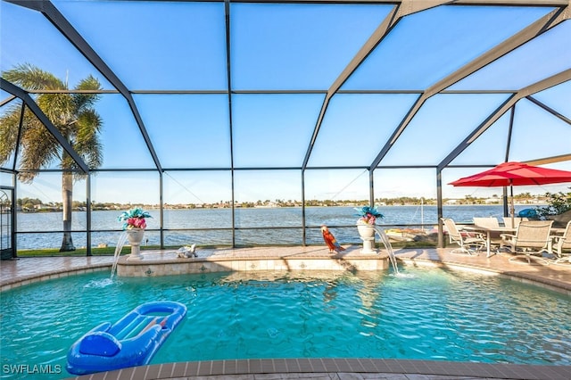 view of pool featuring a patio, a lanai, pool water feature, and a water view